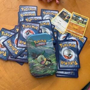 Pokémon cards and metal case over 50 different cards